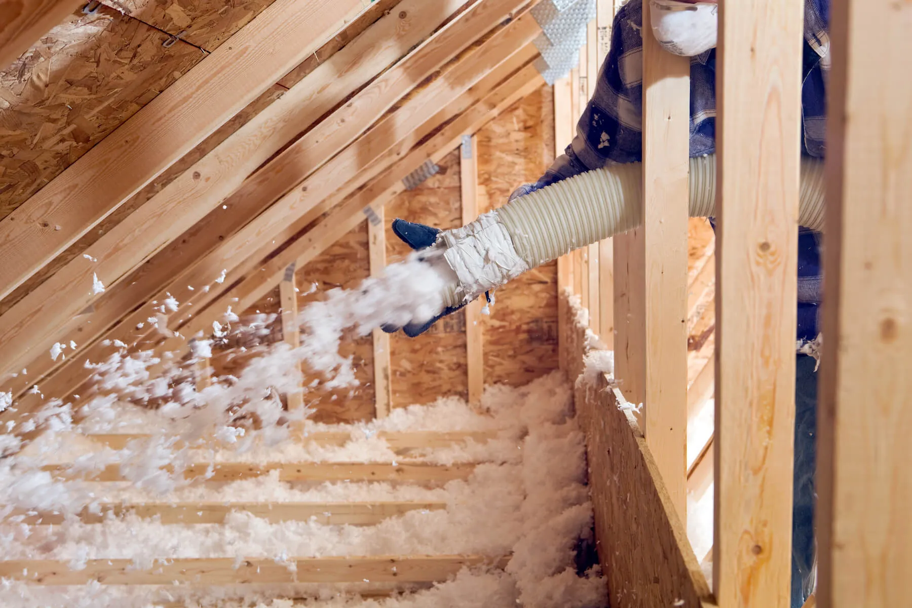 Professional installer applying spray foam insulation in a Mesa-area building